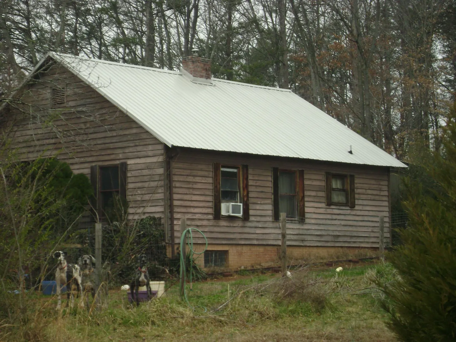 White metal roof on an old wood sided farmhouse, from a Metal Roof Installation job in Cassatt